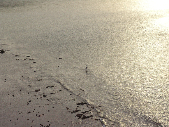 Lonesome fisherboy in ocean calm Bali