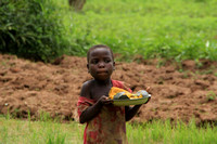 Malawian girl carrying pumpkin